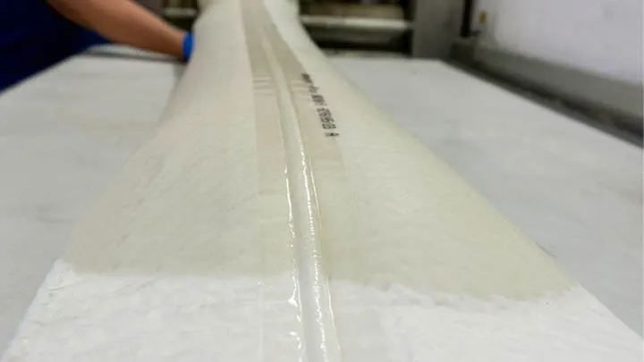 Liner laid out on a table, prepared for lateral pipe rehabilitation