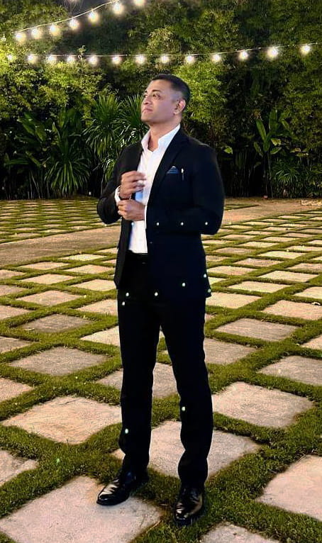 Johann Nassier standing in a garden with cosy lights
