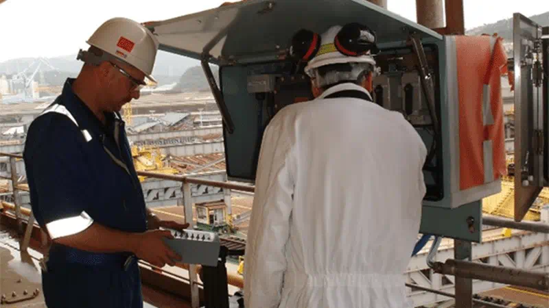 Engineer conducting an on-site health check of a Ship-Shore Link (SSL) system to verify safety and reliability