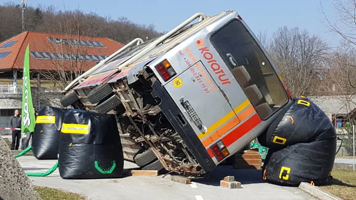 A bus lying in a large catch bag, used for rescue purposes