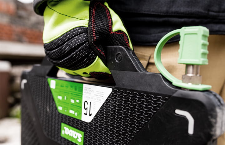 A firefighter's hand holding a lifting bag