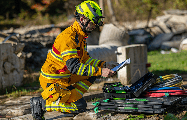A firefighter in uniform reading a catalogue